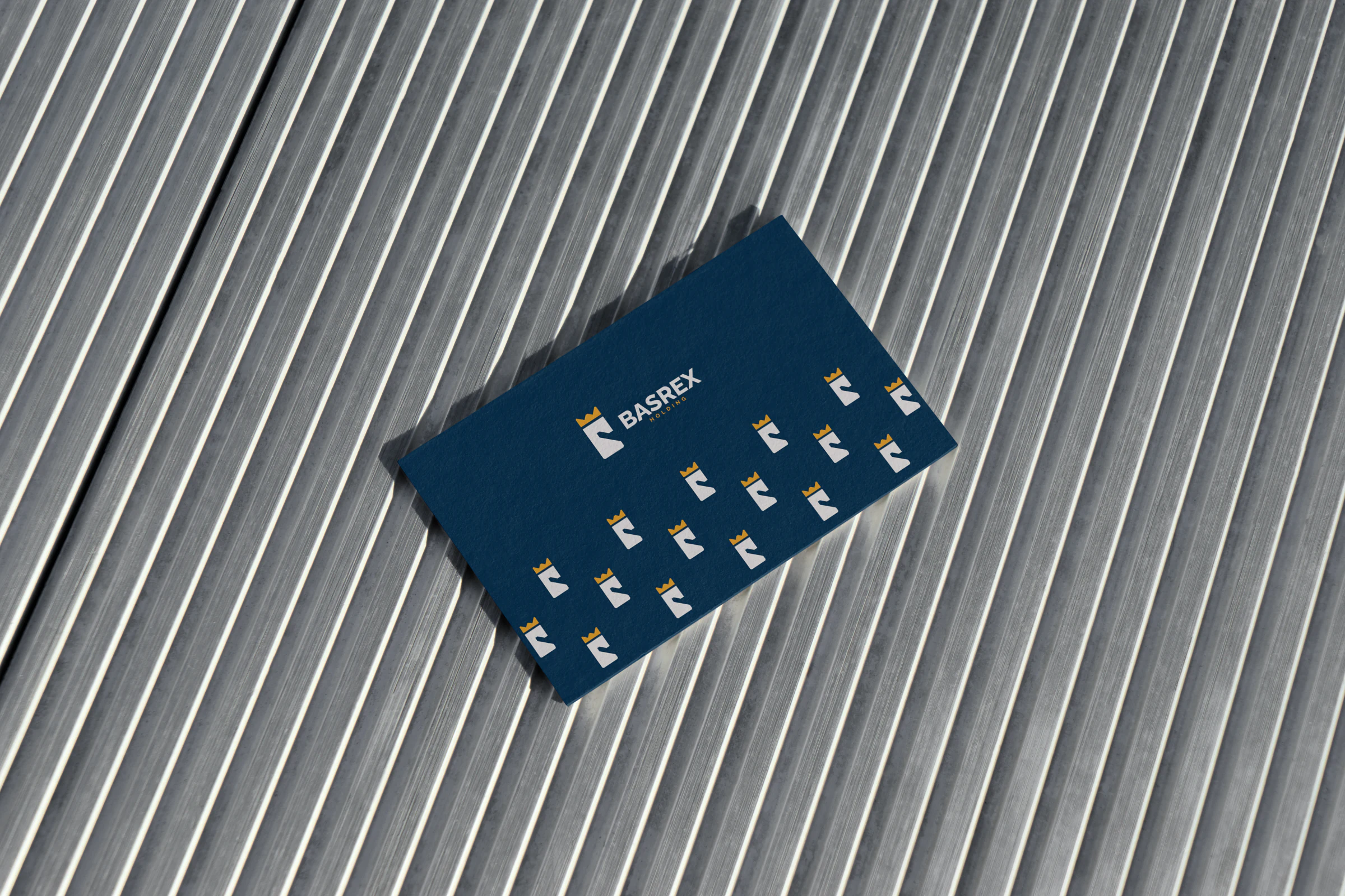 BASREX corporate brand identity on a structured metallic surface